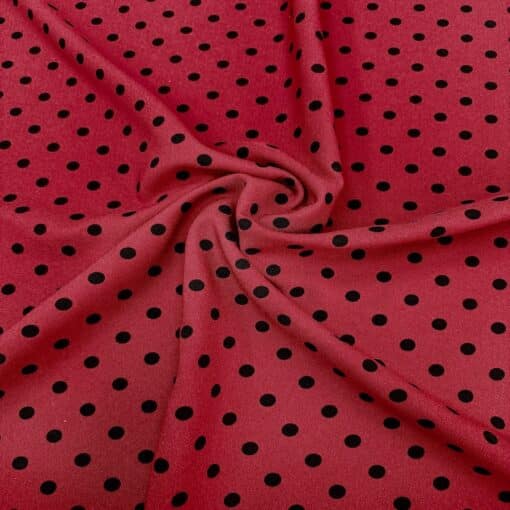 Crêpe polyester fond rouge pois noirs