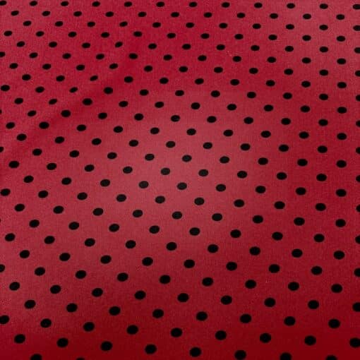 Crêpe polyester fond rouge pois noirs
