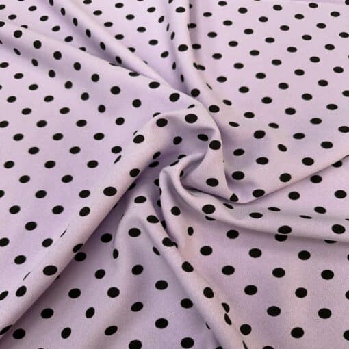 Crêpe polyester fond lilas pois noirs