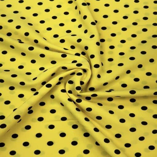 Crêpe polyester fond jaune pois noirs