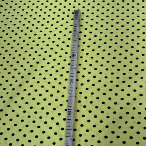 Crêpe polyester fond jaune pois noirs