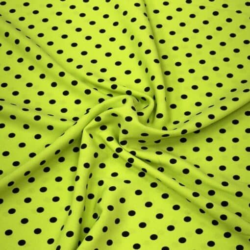 Crêpe polyester fond vert anis pois noirs