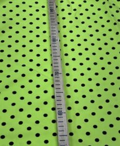 Crêpe polyester fond vert anis pois noirs