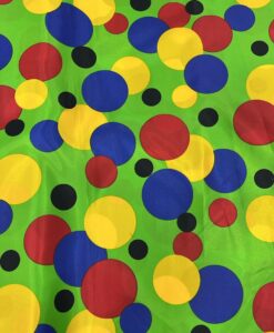 Tissu carnaval imprimé fond vert pois multicolors