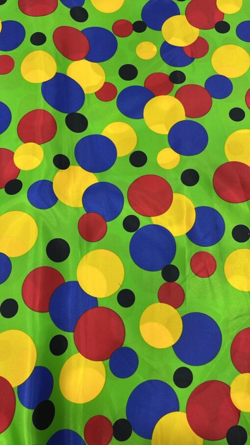 Tissu carnaval imprimé fond vert pois multicolors